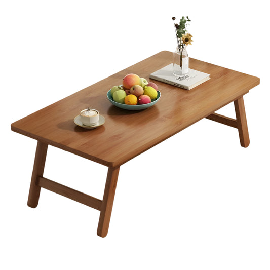 Wooden coffee table with decorative items in a living room setting